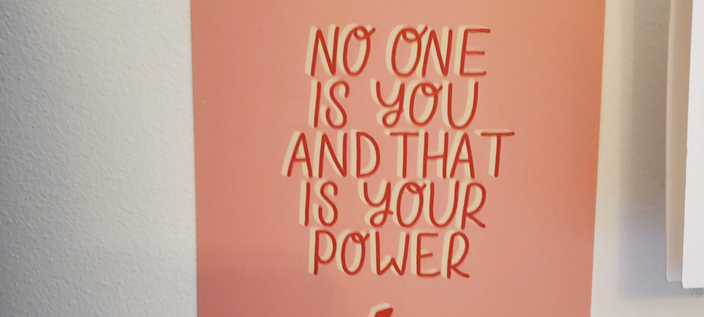 A photo of a card with a caption that reads “No One Is You and That Is Your Power