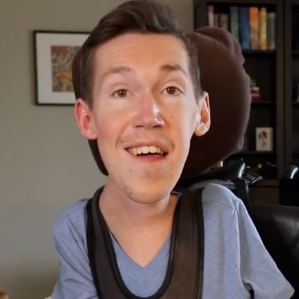Thumbnail of a video of Shane and Hannah talking about supporting each other even through frustrating situations. Shane sits in his wheelchair in front of a black bookshelf and Hannah sits beside him.