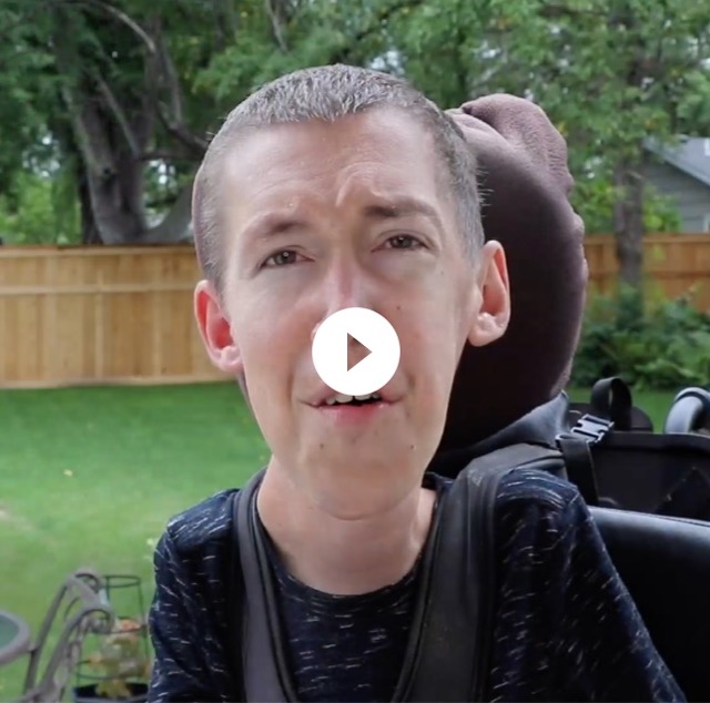 Thumbnail of a video of Shane talking about finding and following your passion. Shane sits outdoors in his wheelchair surrounded by greenery and trees.